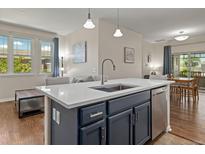 Bright kitchen featuring an island with a sink, stainless steel appliances, and an open floorplan at 837 E 98Th Ave # 405, Thornton, CO 80229