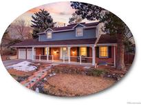 Charming two-story home with a welcoming front porch and well-manicured landscaping at 6721 S Clayton Way, Centennial, CO 80122