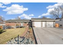 Charming home featuring a two-car garage, brick accents, and a welcoming front deck at 3700 Miller St, Wheat Ridge, CO 80033