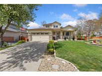 Charming home featuring a well-manicured lawn and a welcoming front porch with great curb appeal at 107 Prairie Falcon Pkwy, Brighton, CO 80601