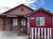 Brick and red siding home with a unique design and landscaping at 571 Geneva St, Aurora, CO 80010