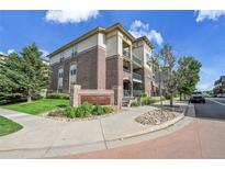 Brick condo building with beautiful landscaping and a sign that reads 'Town Center Terrace' at 3852 S Dallas St # 8-102, Aurora, CO 80014