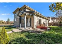 Two-story house with a brick and light-colored siding exterior, and a landscaped lawn at 6500 E Asbury Ave, Denver, CO 80224