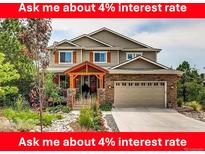 Charming two-story home with a well-manicured front yard and a welcoming covered porch at 1970 Woodbourne Ter, Castle Rock, CO 80104