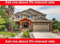 Charming two-story home with a landscaped front yard, stone accents and a two car garage at 1970 Woodbourne Ter, Castle Rock, CO 80104