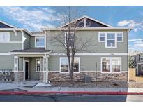 The exterior of this townhome features stone accents, a covered entry, and visible unit number at 17148 Waterhouse Cir # A, Parker, CO 80134