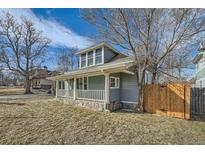 Charming home with a welcoming front porch and stone accents, nestled beneath a bright, partly cloudy sky at 5101 Meade St, Denver, CO 80221