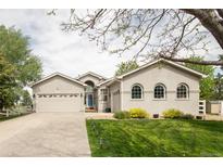 Charming home featuring a well-manicured lawn, attached garage and a welcoming front entrance at 1510 S De Gaulle Cir, Aurora, CO 80018