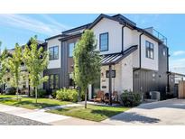 Charming townhome with a modern design, beautiful landscaping, and a welcoming front porch with seating at 3261 S Sherman St, Englewood, CO 80113