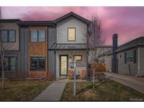 Stylish two-story home boasting modern architectural details, a stone porch, and a well-manicured lawn at 3261 S Sherman St, Englewood, CO 80113