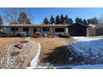 Charming ranch-style home features a well-manicured front yard and a driveway on a sunny day at 5886 S Logan St, Centennial, CO 80121
