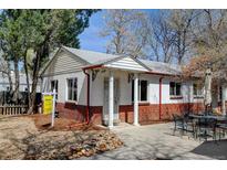 Charming single-story home featuring brick accents, white trim and inviting front patio at 4078 Ames St, Wheat Ridge, CO 80212