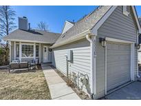 Charming home featuring a well-maintained yard and a welcoming front entrance with comfortable outdoor seating at 6333 Zang Ct # E, Arvada, CO 80004
