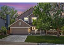 Charming two-story home with stone accents, a well-manicured lawn, and an attached two-car garage at 1744 Brookside Dr, Highlands Ranch, CO 80126