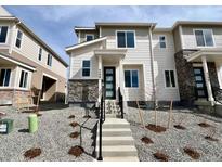 Charming two-story townhome with stone accents and a well-maintained front yard at 4598 S Versailles St # A, Aurora, CO 80015