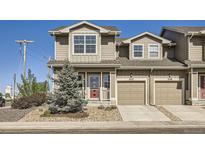 Charming two-story townhome featuring a private porch and a one car garage in a well-maintained community at 202 Ash St, Bennett, CO 80102