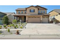 Charming two-story home featuring a three-car garage and well-maintained landscaping at 18984 W 85Th Blf, Arvada, CO 80007