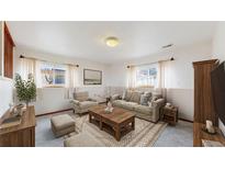 Cozy living room with neutral tones, large area rug, and comfortable seating arrangements at 412 N 10Th Ave, Brighton, CO 80601