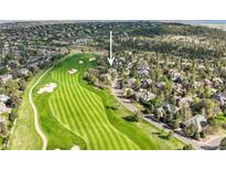 Beautiful aerial view of a golf course community with tree lined streets and well-maintained lawns at 7120 Forest Ridge Cir, Castle Pines, CO 80108