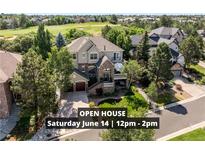Beautifully landscaped two-story home with a stone facade and inviting front porch at 7120 Forest Ridge Cir, Castle Pines, CO 80108