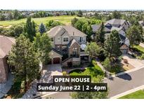 Beautiful two-story home with stone accents, a front porch, mature trees and an attached garage at 7120 Forest Ridge Cir, Castle Pines, CO 80108