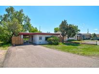 Charming single-story home with a spacious driveway and well-maintained lawn, perfect for a Gathering at 1560 Simms St, Lakewood, CO 80215