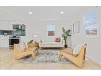 Bright living room features light hardwood floors, and ample natural light, and provides an open floor plan at 1130 Orchard St, Golden, CO 80401