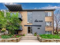 Brick apartment building featuring gray accents, balconies and professional landscaping at 200 N Sherman St # 7, Denver, CO 80203