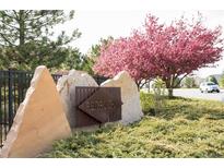Redbuck community sign with a flowering tree in the background on a sunny day at 5732 S Addison Way # E, Aurora, CO 80016