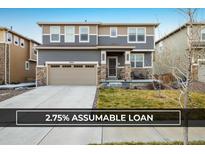 Charming two-story home with a two-car garage and a well-maintained front yard at 9283 Sedalia St, Commerce City, CO 80022