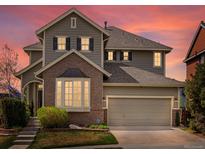 Charming two-story home with a well-maintained lawn, two-car garage, and beautiful bay window at 10273 Salida St, Commerce City, CO 80022