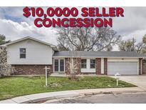 Charming two-story home featuring a well-maintained lawn and a convenient attached garage at 7791 S Columbine St, Centennial, CO 80122