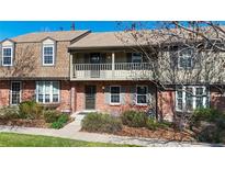 Charming two-story townhouse boasts a brick facade, balcony and a well-maintained front garden at 8752 E Amherst Dr # D, Denver, CO 80231