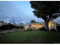 Charming single-story home with a well-manicured lawn and mature tree, perfect for families at 9220 Lowell Blvd, Westminster, CO 80031