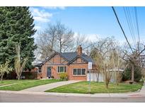 Charming brick home with a well-maintained lawn, mature trees, and inviting curb appeal at 795 N Jersey St, Denver, CO 80220