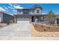 Charming two-story home with stone accents, landscaped yard, and two car garage at 8339 Snake River St, Littleton, CO 80125
