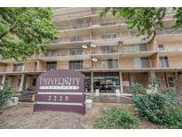 Image of the University Park Tower featuring a front sign with the address and lush green trees in the foreground at 2225 Buchtel Blvd # 208, Denver, CO 80210