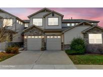Charming townhome with stone accents and a two-car garage, perfect for modern living at 23070 York Ave, Parker, CO 80138