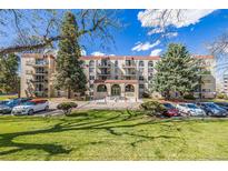 Inviting condo building with well-maintained lawns, lush trees, and ample parking for residents and guests at 7801 W 35Th Ave # 406, Wheat Ridge, CO 80033