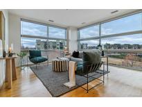 Spacious living room with large windows and city views at 2958 Syracuse St # 303, Denver, CO 80238