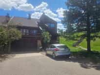 Modern two-story home with a private balcony and a two-car garage, offering a blend of style and functionality at 4484 Juniper Ct, Larkspur, CO 80118