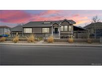 Charming single-Gathering home featuring a well-manicured lawn and a welcoming front porch at 6595 Meade Ct, Arvada, CO 80003