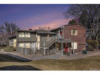 Charming multi-Gathering home with brick accents and well-maintained landscaping at dusk at 857 S Van Gordon Ct # G208, Lakewood, CO 80228