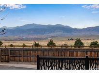 Expansive backyard view showcasing open space and mountain views in the distance at 11551 W 103Rd Dr, Broomfield, CO 80021