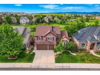 Charming two-story home with a well-manicured lawn and beautiful landscaping in a desirable neighborhood at 854 Countrybriar Ln, Highlands Ranch, CO 80129