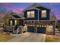 Charming two-story home featuring a stone facade, a covered porch, and a two-car garage at 2730 River View Dr, Broomfield, CO 80023