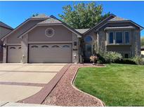 Charming home featuring a well-manicured lawn and a two-car garage at 6833 S Miller St, Littleton, CO 80127