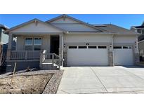 Charming single-Gathering home featuring a two-car garage, covered porch, and professionally landscaped front yard at 615 Twilight St, Erie, CO 80516