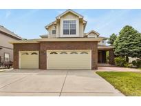 Charming two-story home featuring a brick facade and a spacious three-car garage at 6533 S Ouray St, Aurora, CO 80016