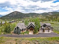 Spectacular mountain home featuring beautiful architecture, professional landscaping, and a large circular driveway at 174 Sage Dr, Breckenridge, CO 80424